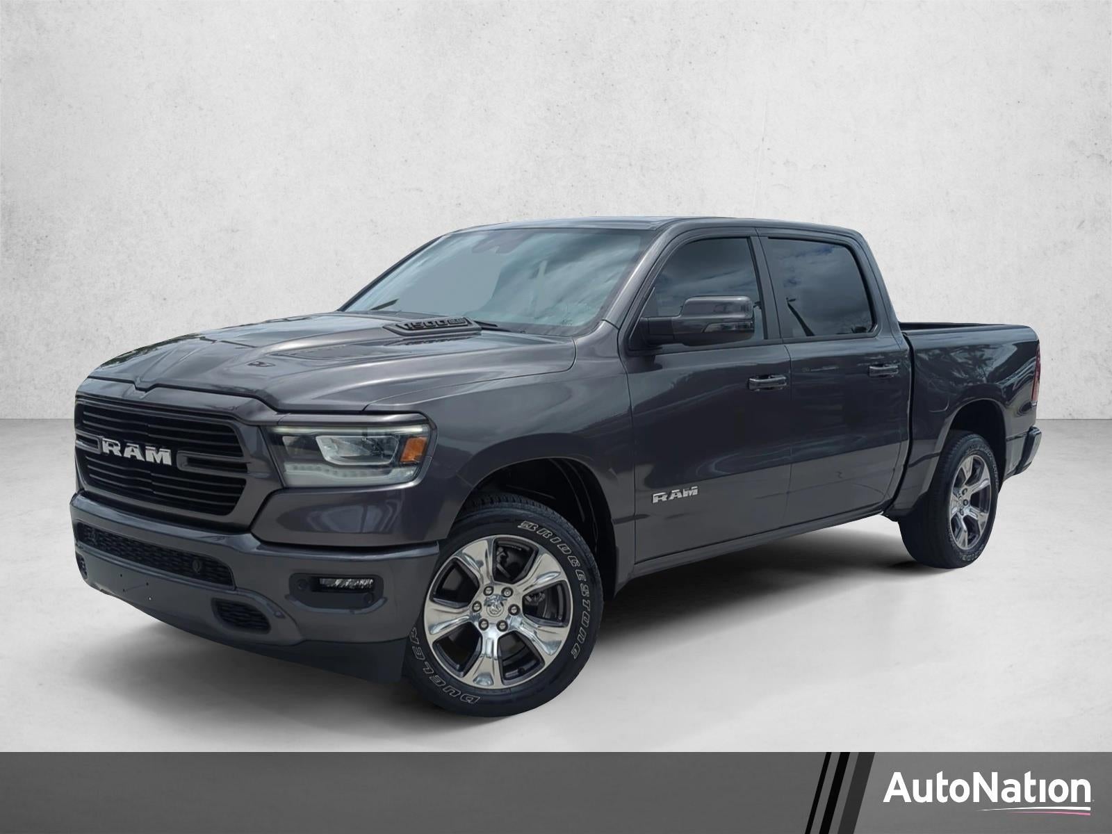 2024 RAM 1500 Laramie 4x4 Crew Cab 5'7" Box in Granite Crystal Metallic Clearcoat — front three-quarter view