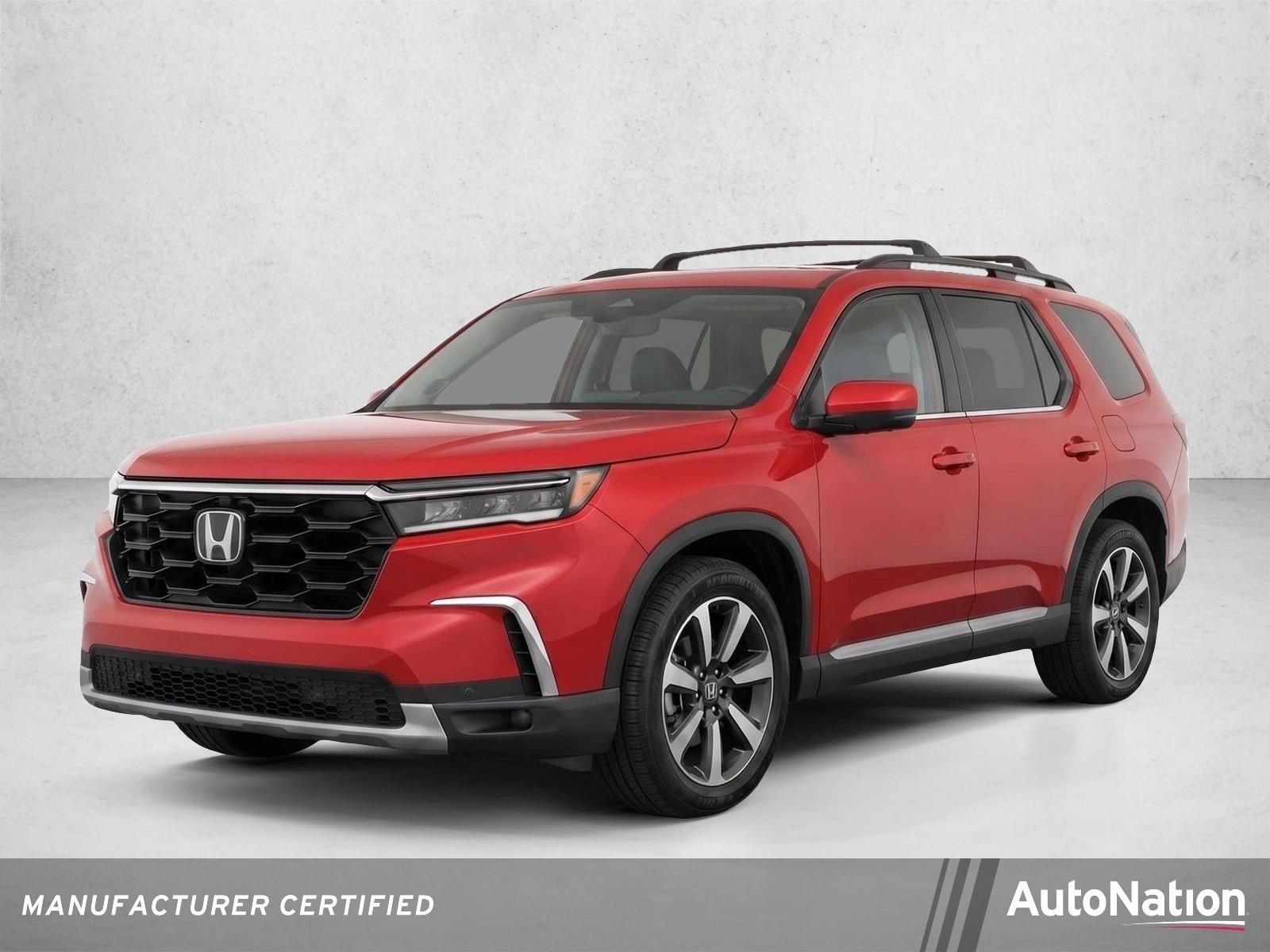 2023 Honda Pilot Touring 2WD in Radiant Red Metallic II — front three-quarter view